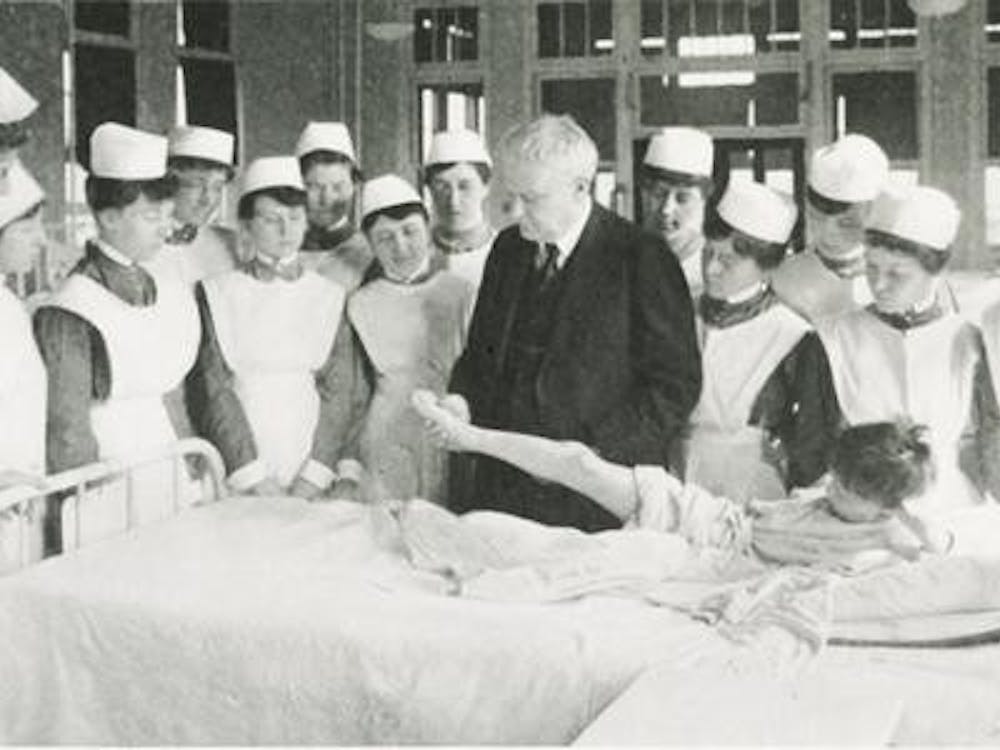 Nursing students stand at bedside clinic at Long Hospital in 1919. 
