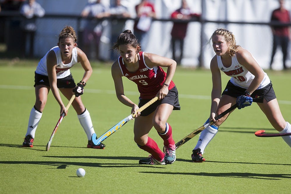 Senior midfielder Caitlin Bearish evades two Lousiville defenders on Sunday at the Field Hockey Complex. Indiana lost 2-0 in their final home game of the season. 