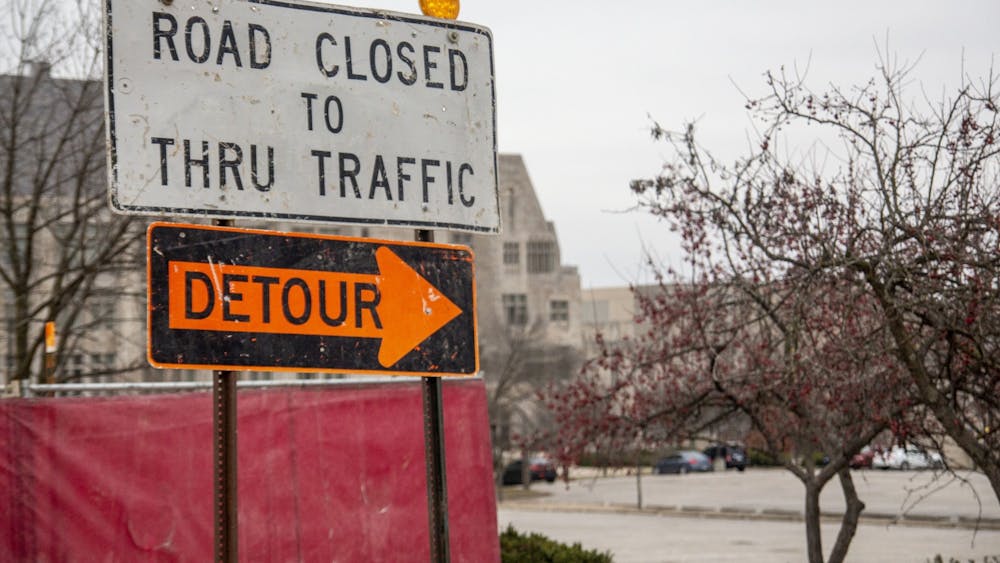 A sign directs traffic around a construction project Dec. 6 near Luddy Hall. The City of Bloomington is in the midst of multiple construction projects aimed to better the community and improve the quality of life for residents, including bus stop and sidewalk improvements, Campus River upgrades and a new playground.