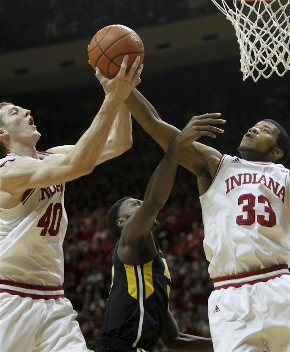 Both sophomore Cody Zeller and freshman Jeremy Hollowell reach for a layup Saturday during the Hoosier's 73-60 win against Iowa in Assembly Hall.