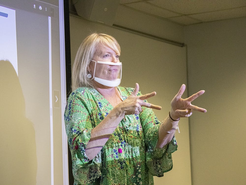 IU professor Debbie Gessinger helps students in her American Sign Language class Oct. 20, 2021, at Lindley Hall. She and her students wear clear masks in class so they can accurately communicate using ASL.