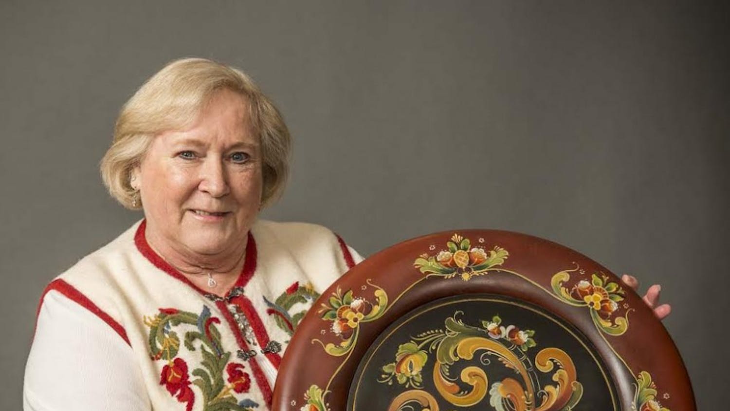 Jan Boettcher with an example of her work with rosemaling, a Norwegian painting technique. Boettcher will be one of two artists demonstrating their craft at the Mathers Museum of World Cultures on Thursday.