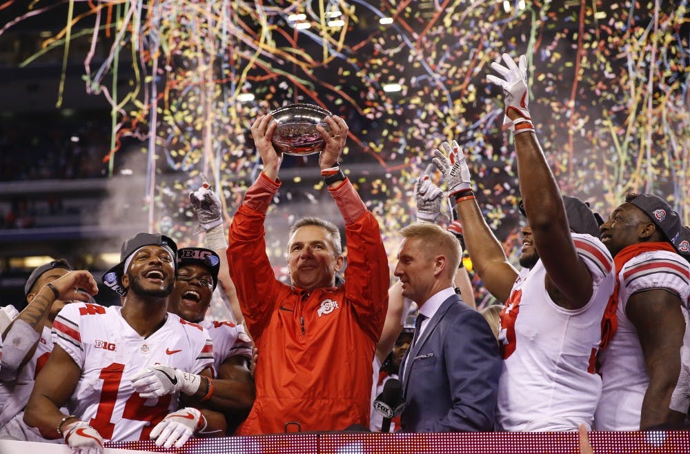 Ohio State Buckeyes head coach Urban Meyer celebrates with his team after their 27-21 Big Ten Championship win over the Wisconsin Badgers in 2017.