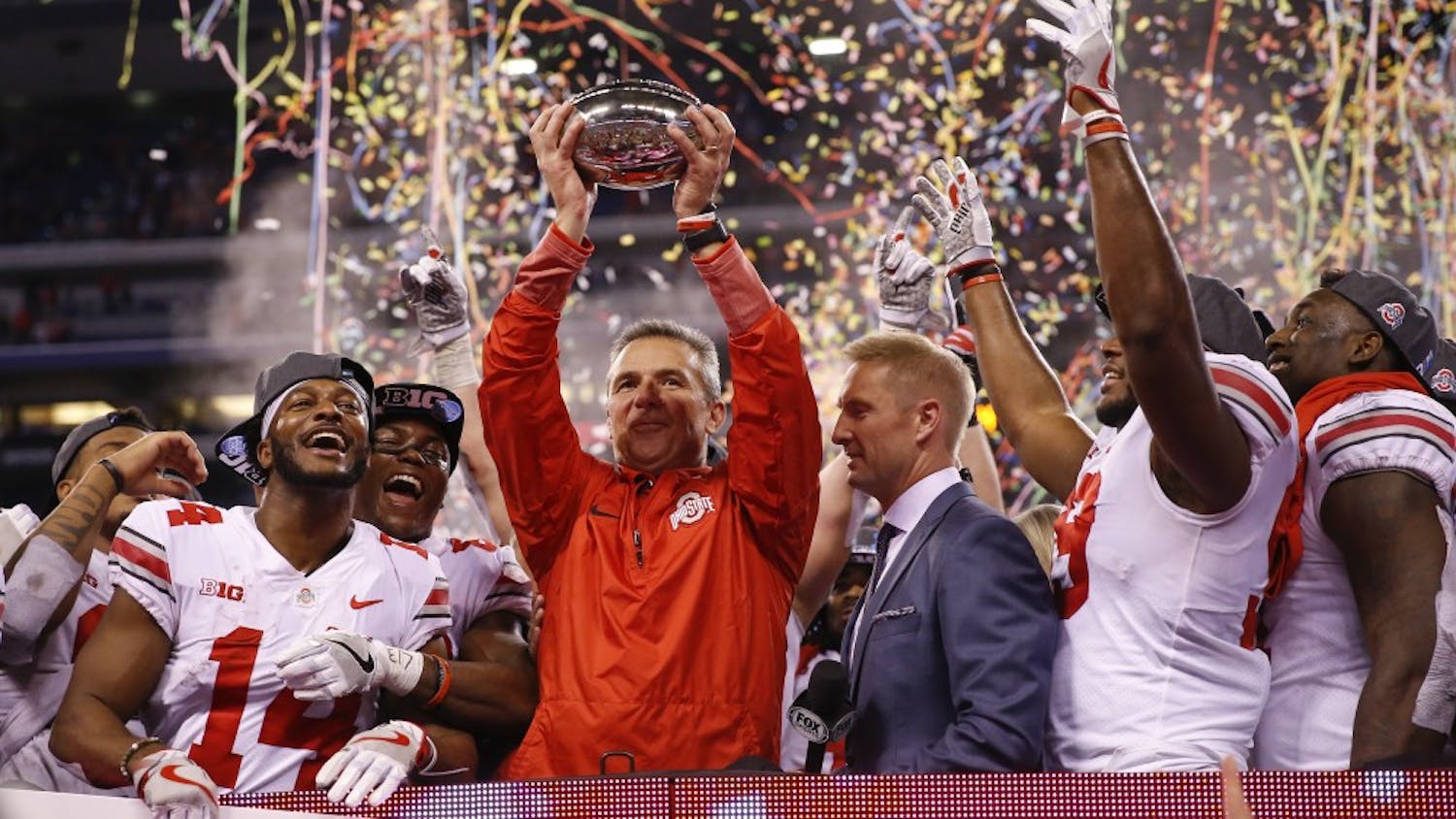 Ohio State Buckeyes head coach Urban Meyer celebrates with his team after their 27-21 Big Ten Championship win over the Wisconsin Badgers in 2017.