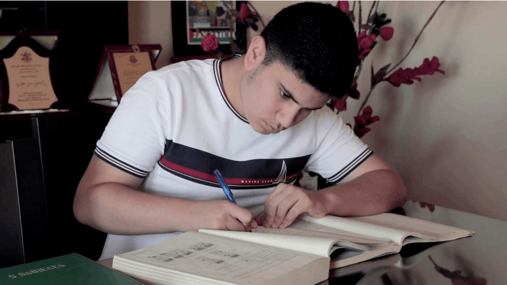 Ismail Ajjawi writes in his home near the El Buss refugee camp in Lebanon. The Harvard freshman who said he was was denied U.S. entry because of his friends&#x27; social media postings arrived in Boston in time for the start of classes.