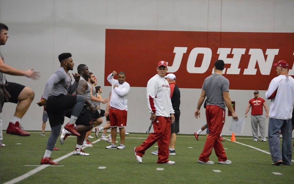 IU Coach Tom Allen walks through football players during practice in March in John Mellencamp Pavilion.&nbsp;