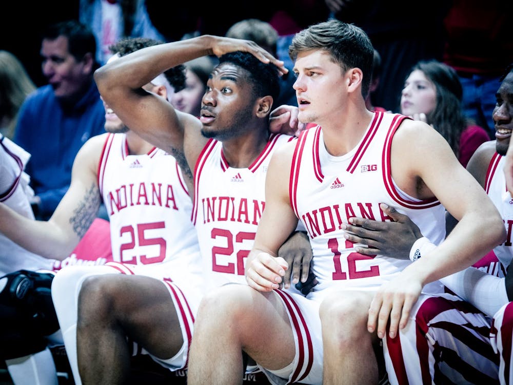 Sophomore Jordan Geronimo and graduate student Miller Kopp react to a Trayce Jackson-Davis dunk in the first half Jan. 22, 2023, at Simon Skjodt Assembly Hall in Bloomington, Indiana. The Hoosiers beat Minnesota 61-57 Wednesday night.