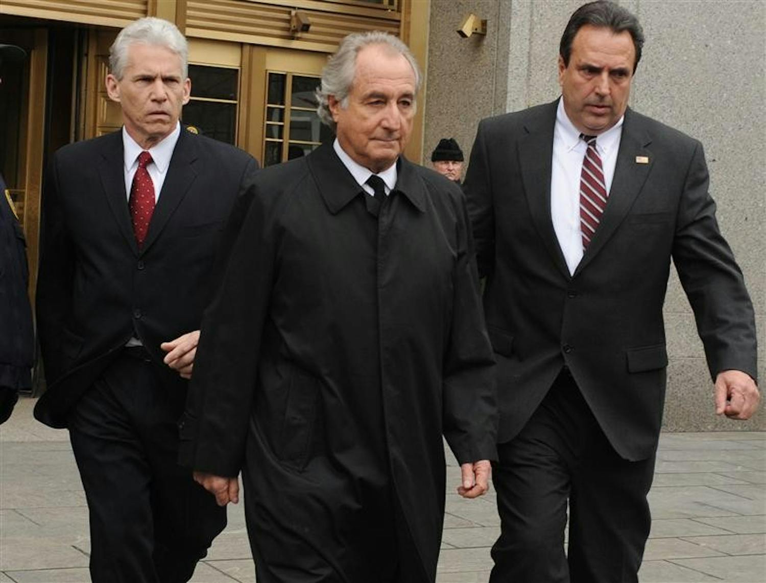 Bernard Madoff exits Manhattan federal court Tuesday in New York. Bernard Madoff will plead guilty Thursday to 11 criminal counts including money laundering, perjury and securities, mail and wire fraud and will do so without a plea deal, knowing it carries a potential prison term of 150 years, lawyers said Tuesday in court. (AP Photo/ Louis Lanzano)