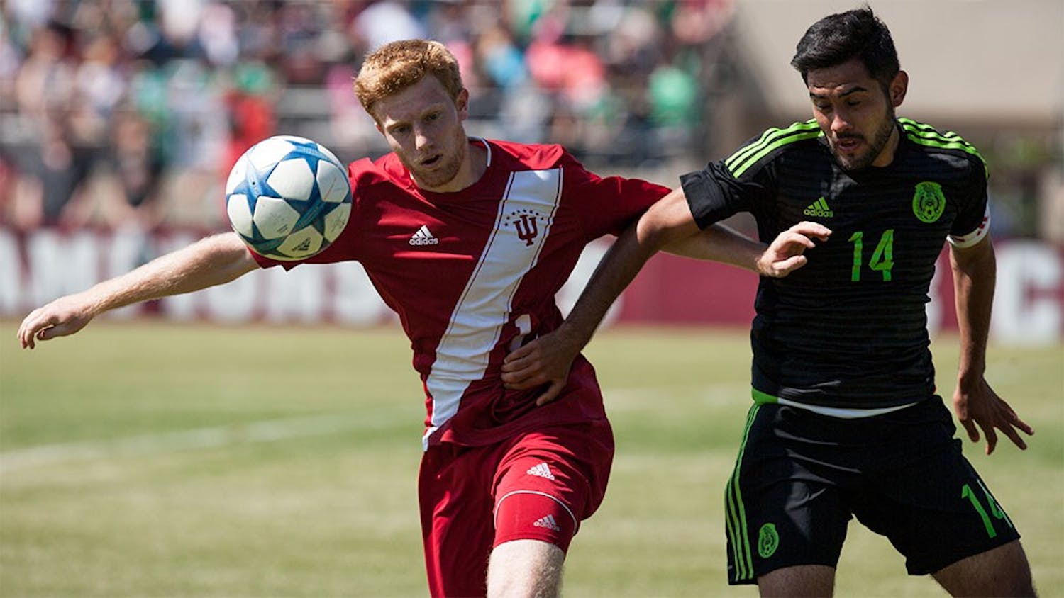 Freshman midfielder Cory Thomas fights off a Mexican player for the ball in the goal box Sunday at Bill Armstrong Stadium. The Hoosiers beat the Mexican U-20 National Team 2-0.