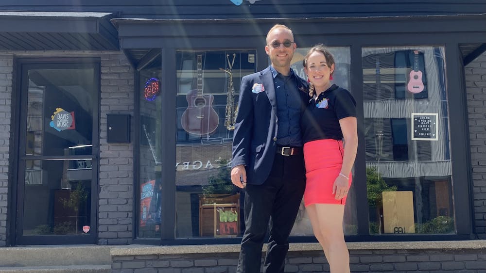 IU alumni Craig and Emily Davis stand outside their new music academy in downtown Bloomington. The Davis Academy of Music opended to the public July 31, 2023.