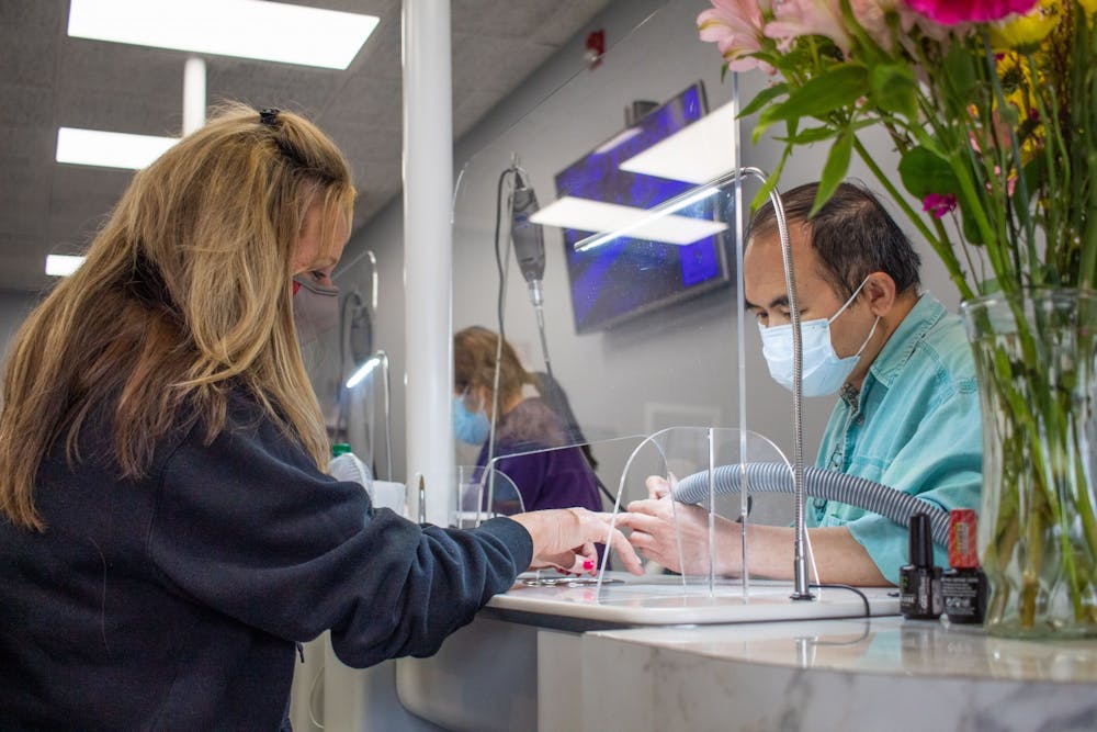 <p>Nikki Nails employee Kevin Nguyen gives a manicure to a customer. Nikki Nails on West Third Street is an appointment-only salon that offers manicures, pedicures, full acrylic sets and gel nails. </p><p></p><p>Kevin Nguyen </p>