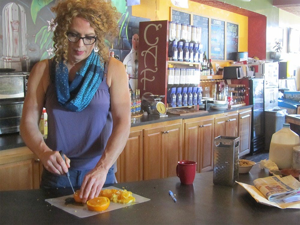 Rachael Jones slices oranges for her famous orange chocolate cookies.  For the past eight years, Rachael's Cafe has held residence on the corner of 3rd and Lincoln St.  This Saturday the cafe will close for good.