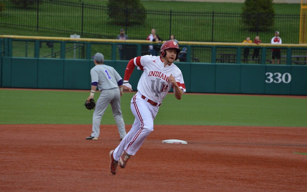 Sophomore infielder Matt Lloyd runs to third base after his teammate, Tony Butler, hit a grounder to left field. Butler brought in two runs and pushed the Hoosiers into the lead against the Evansville Aces.&nbsp;