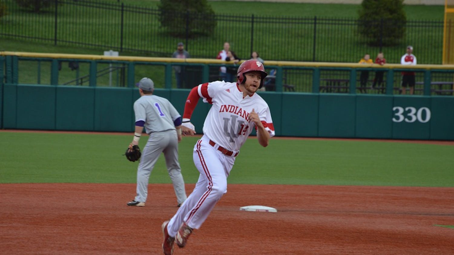 Sophomore infielder Matt Lloyd runs to third base after his teammate, Tony Butler, hit a grounder to left field. Butler brought in two runs and pushed the Hoosiers into the lead against the Evansville Aces.&nbsp;