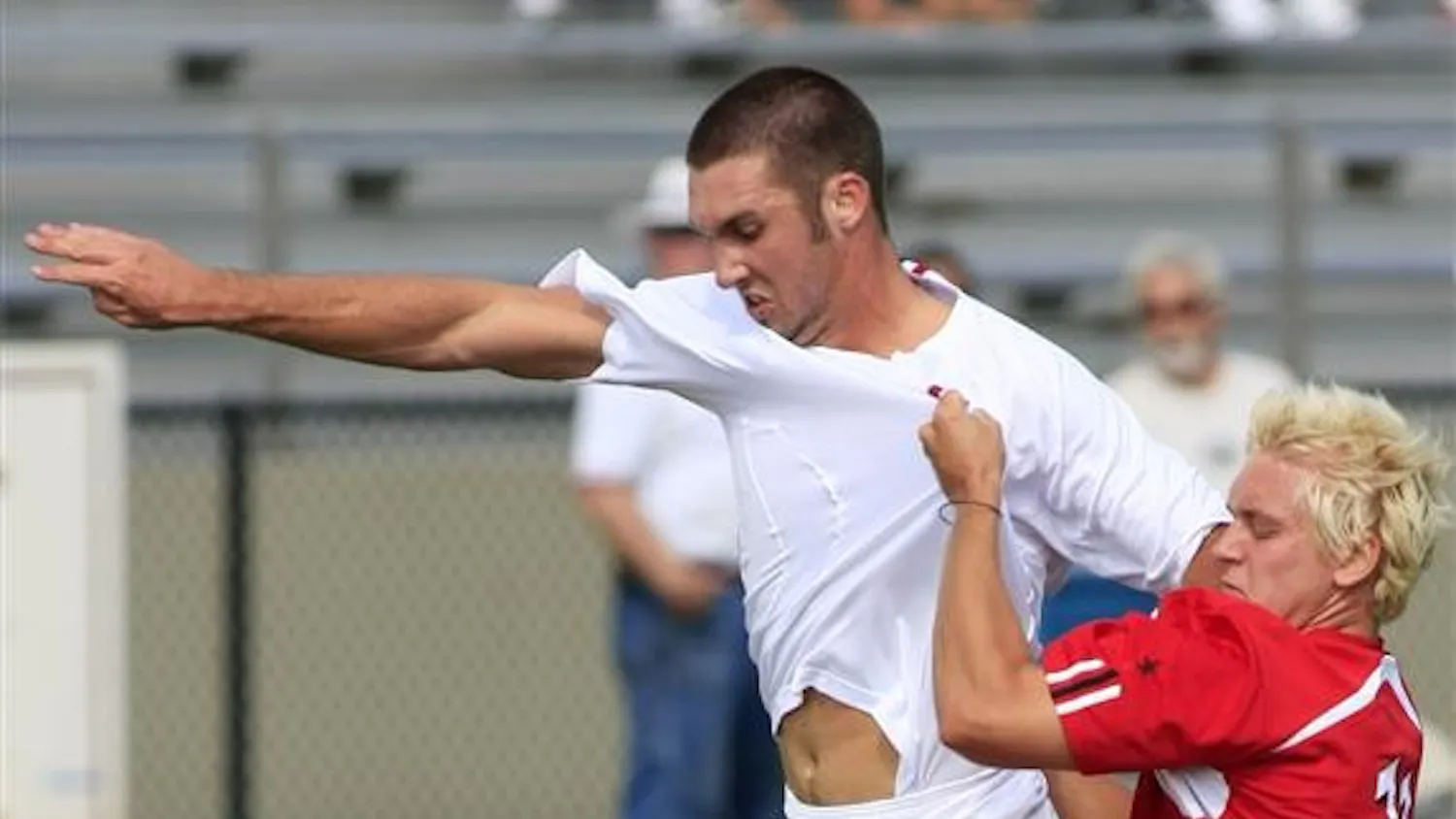 Freshman Will Bruin, left, struggles to retain possession of the ball as Wisconsin's Eric Conklin grabs his shirt during a game on Sunday at Bill Armstrong Stadium.