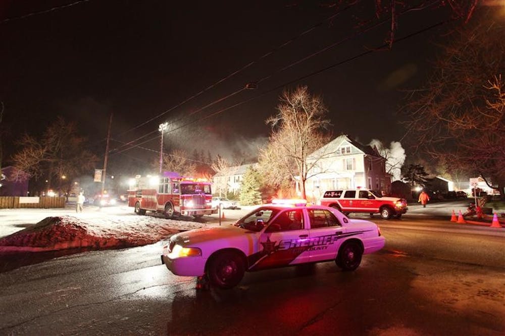 Emergency workers head to the scene to extinguish the fire at the site of the crash of Continental Connection Flight 3407 on Friday in Clarence Center, N.Y.