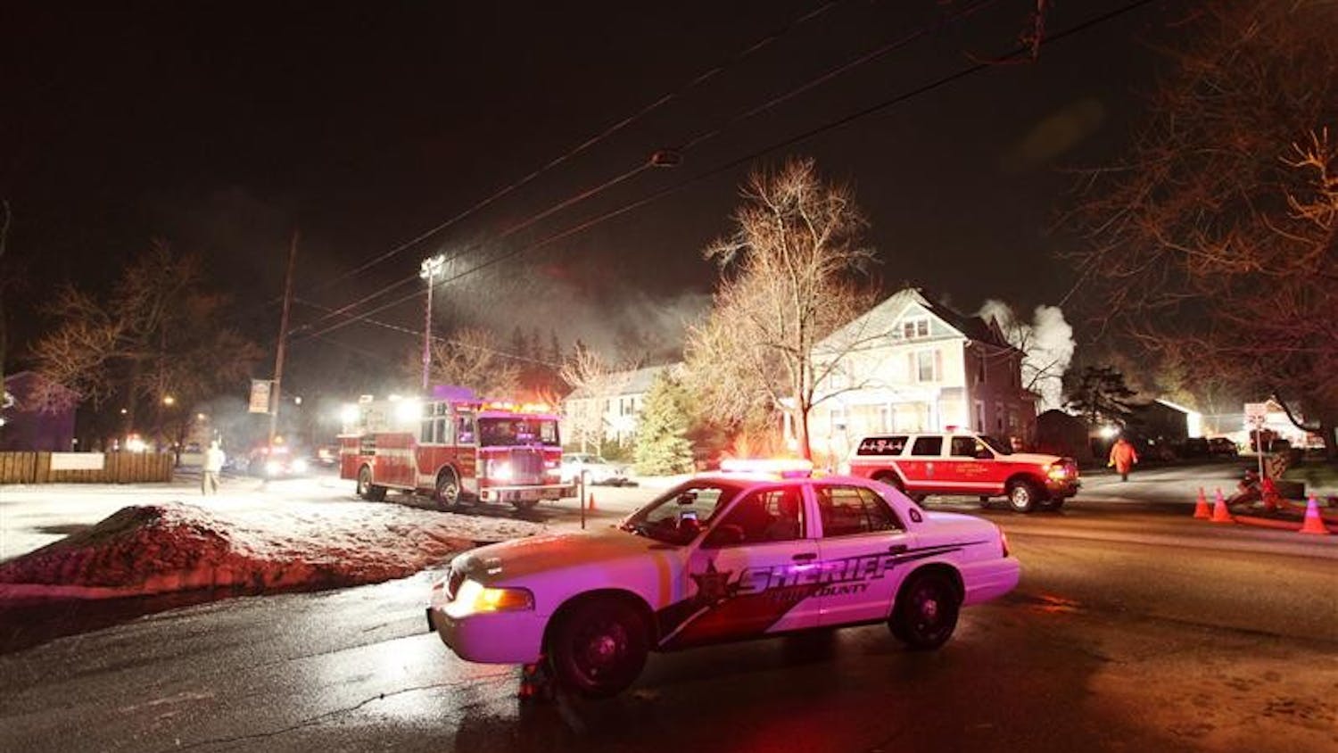 Emergency workers head to the scene to extinguish the fire at the site of the crash of Continental Connection Flight 3407 on Friday in Clarence Center, N.Y.