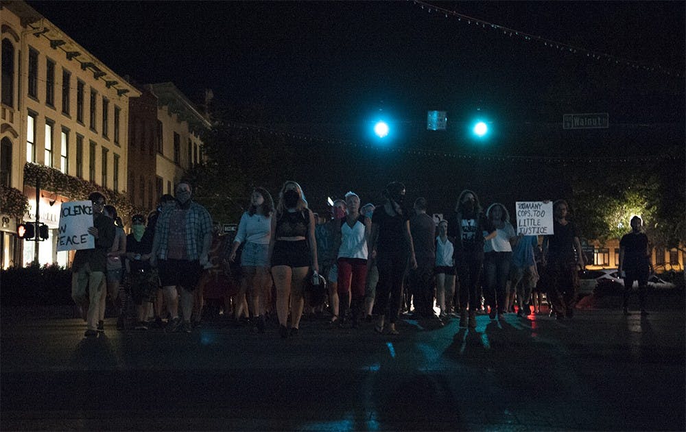 People march down Kirkwood Street and chant "Yes means yes and no means no!" on Thursday night in a rally against rape. The event was organized by the group Students Against State Violence. 
