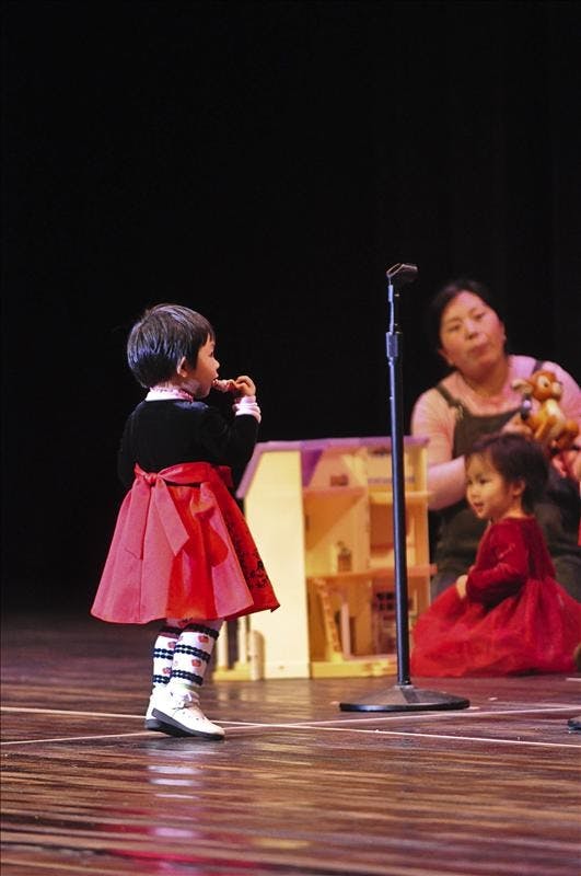 A little girl dances, as children from the Chinese Language School perform "If You're Happy And You Know It," Saturday evening at the Chinese New Year celebration held at the IU Auditorium.