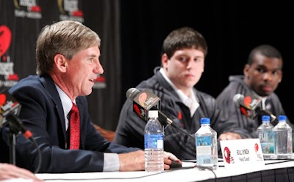 IU coach Bill Lynch addresses the media while senior co-captains Josiah Sears and Tracy Porter look on. The Hoosiers will face Oklahoma State in the Insight Bowl on Dec. 31.