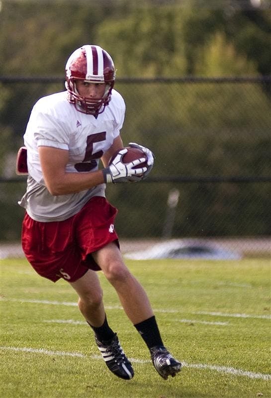IU wide receiver Mitchell Evans, right, makes a catch in practice on Tuesday at the football practice field. Evans, a sophomore, has played at the quarterback and safety positions before moving to wide receiver.