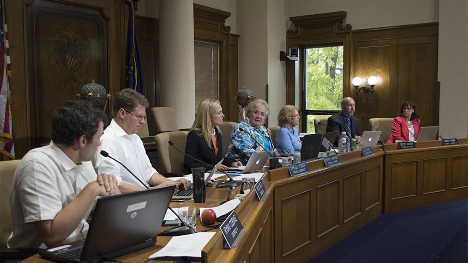 City council members discuss the meeting agenda on Tuesday. 