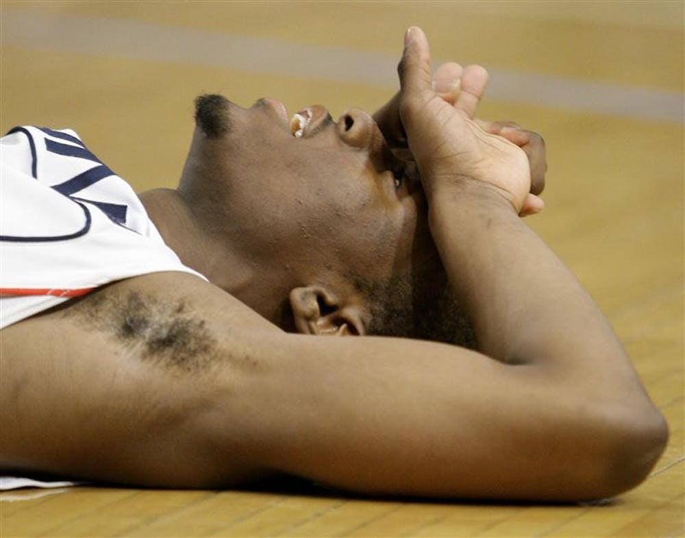 Connecticut's Kemba Walker lays on the floor after missing a shot at the end of the fifth overtime period against Syracuse during a quarterfinal NCAA college basketball game at the Big East men's tournament Thursday at Madison Square Garden in New York. Syracuse won 127-117.