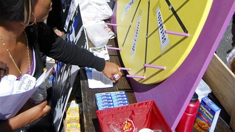 Freshman Tranica Wills spins the prize wheel at the Baptist Collegiate Ministry stand during the Student Involvement Fair on Sept. 8, 2010 in the Indiana Memorial Union parking lot. The fair hosted groups as diverse as the St. Paul Catholic Center and the Secular Alliance of IU. 
