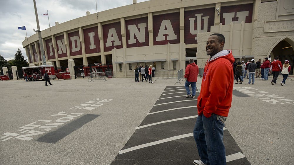 Jeffery walks by Memorial Stadium to get to his usual street corner. University policy prohibits ticket scalping on campus grounds, so when he walks through the parking lots he abides by the policy and places his sign under his shirt, until he reaches the south side of 17th St. The more he looks like a casual fan, the less he will be hassled while on campus gronds.