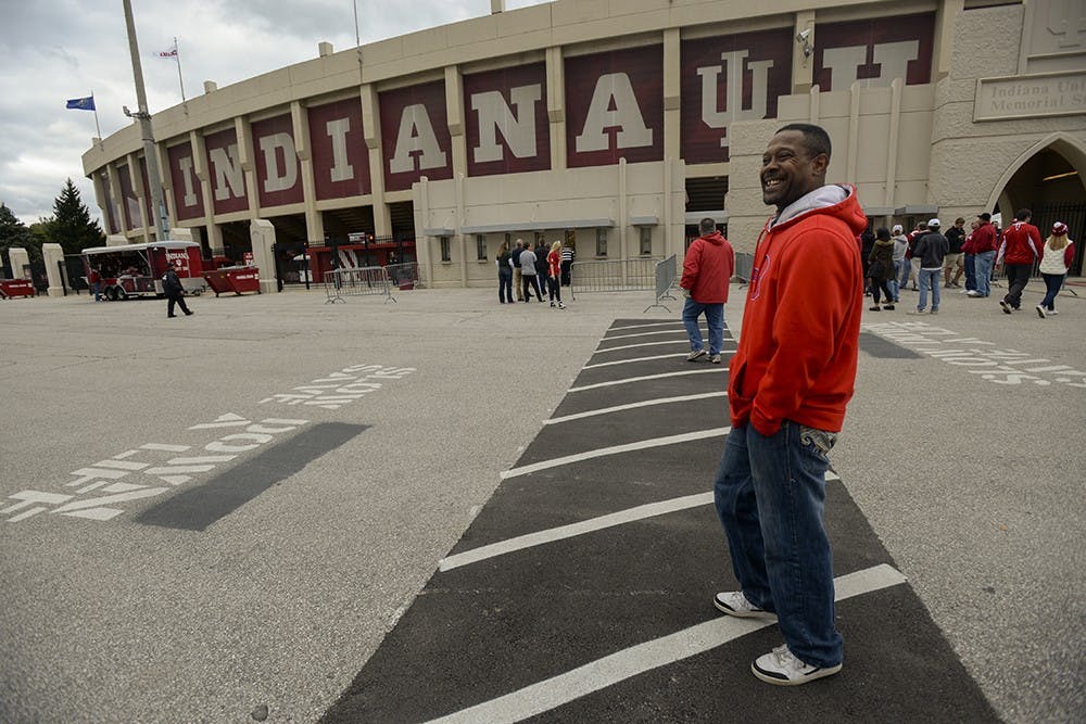 Jeffery walks by Memorial Stadium to get to his usual street corner. University policy prohibits ticket scalping on campus grounds, so when he walks through the parking lots he abides by the policy and places his sign under his shirt, until he reaches the south side of 17th St. The more he looks like a casual fan, the less he will be hassled while on campus gronds.