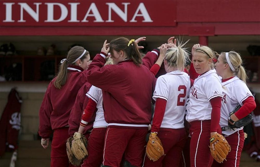 The IU softball team huddles up before a game April 8 at the IU Softball Field. The Hoosiers play Ball State 3 p.m. today at home.