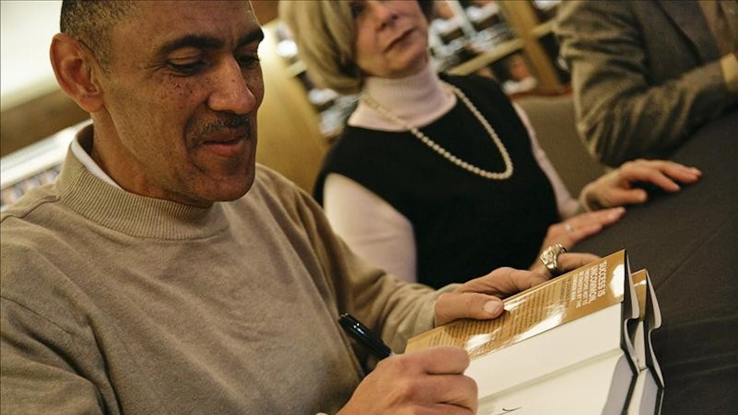Former Indianapolis Colts head coach Tony Dungy signs copies of his new book "Uncommon," Thursday afternoon in the IU Bookstore. Dungy recently retired from his coaching position with the Colts, who won the Superbowl in 2007, making Dungy the first African-American coach to win the Superbowl.