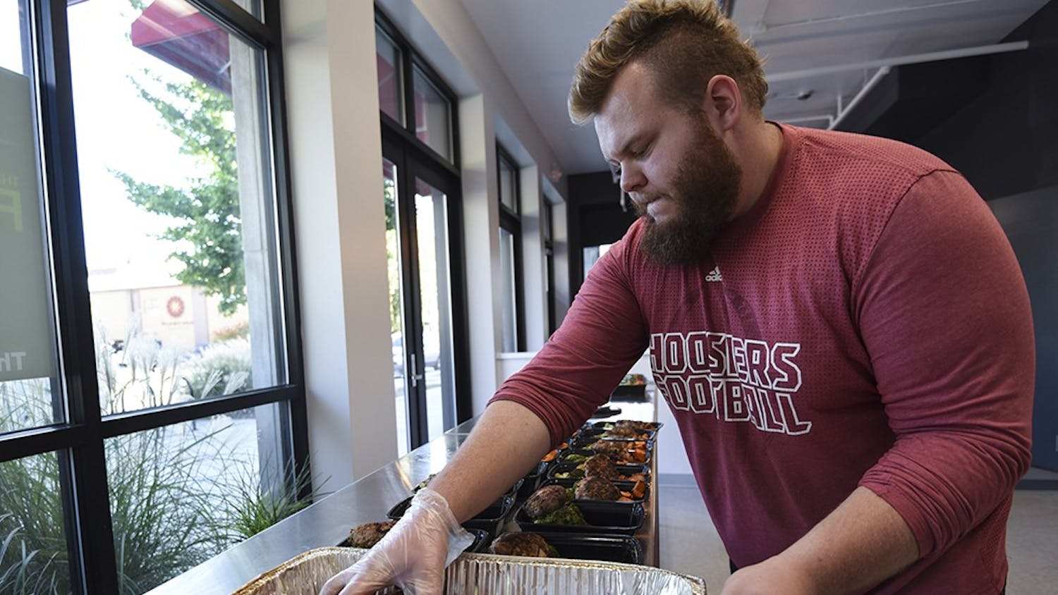 Travis Leonard, assistant kitchen manager, assembles meals in The Fresh Fork on Thursday. The Fresh Fork is a custom meal ordering service that delivers food to Willkie and Eigenmann residence halls and to Bloomingfoods.