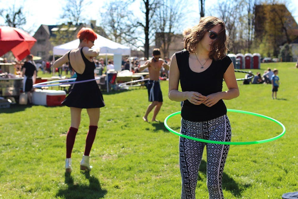 Erica Beauchamp (right), a senior at Indiana University, hula-hoops during the Culture Shock Music Festival held by WIUX on Saturday.