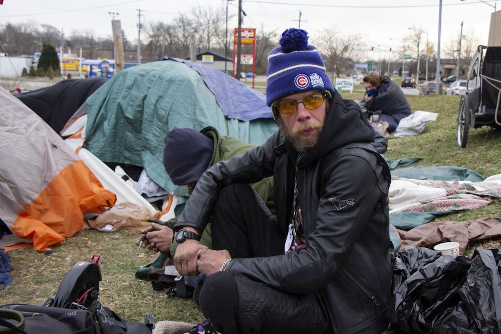 <p>Bloomington resident Daniel Floyd sits by his tent Jan. 14 in Seminary Park. Bloomington City Council members drafted a new ordinance that provides protection for people experiencing homelessness. The ordinance will not be discussed at a council meeting until at least mid-February.  </p>