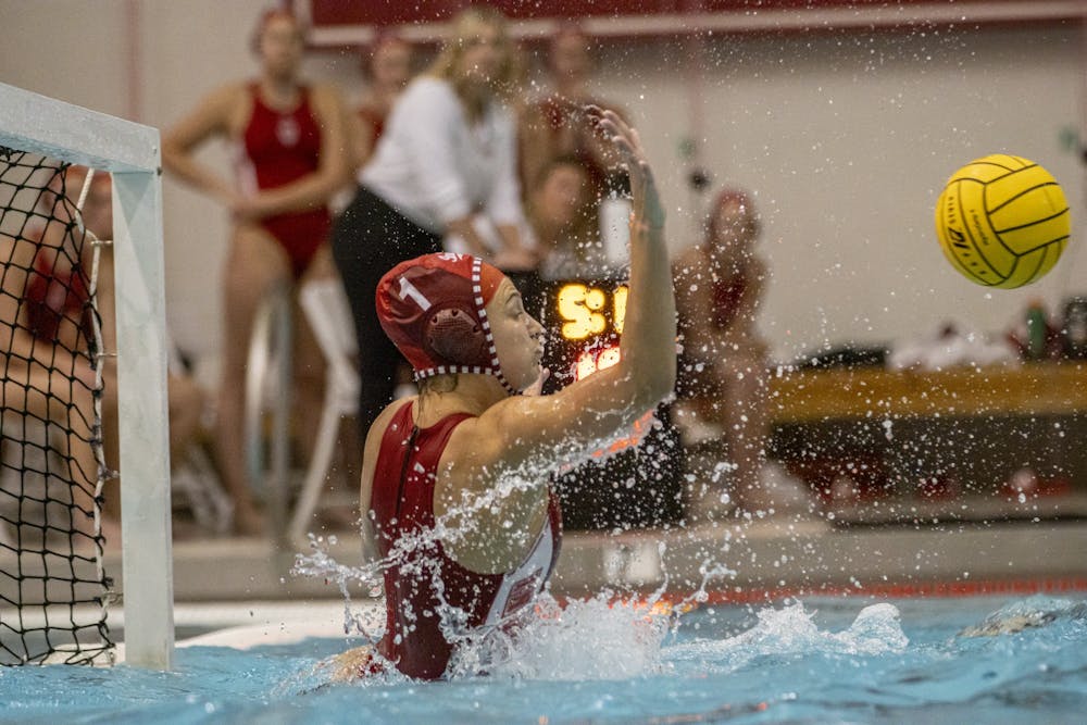 <p>Senior goalkeeper Mary Askew rises to block a shot during the match against the University of California, Berkeley  on March 21, 2022, at the Counsilman-Billingsley Aquatic Center. Indiana fell in its home opener 15-5.</p>