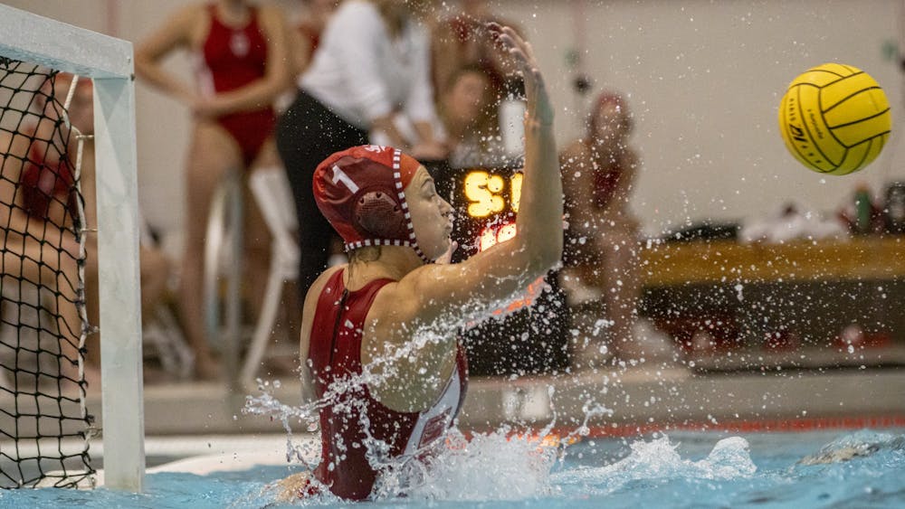 Senior goalkeeper Mary Askew rises to block a shot during the match against the University of California, Berkeley  on March 21, 2022, at the Counsilman-Billingsley Aquatic Center. Indiana fell in its home opener 15-5.