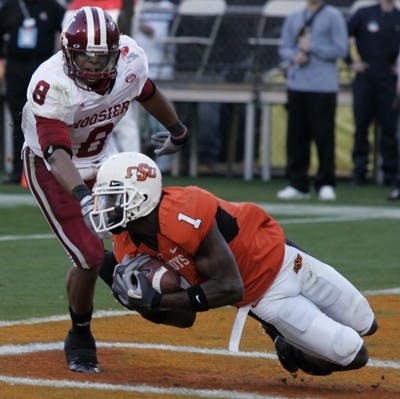 Jay Seawell IDSOklahoma State freshman wide receiver Dez Bryant hauls in a touchdown catch against IU junior safety Nick Polk during the first quarter of the 2007 Insight Bowl Monday night at Sun Devil Stadium in Tempe, Ariz. 