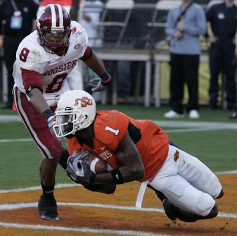 Jay Seawell IDSOklahoma State freshman wide receiver Dez Bryant hauls in a touchdown catch against IU junior safety Nick Polk during the first quarter of the 2007 Insight Bowl Monday night at Sun Devil Stadium in Tempe, Ariz. 