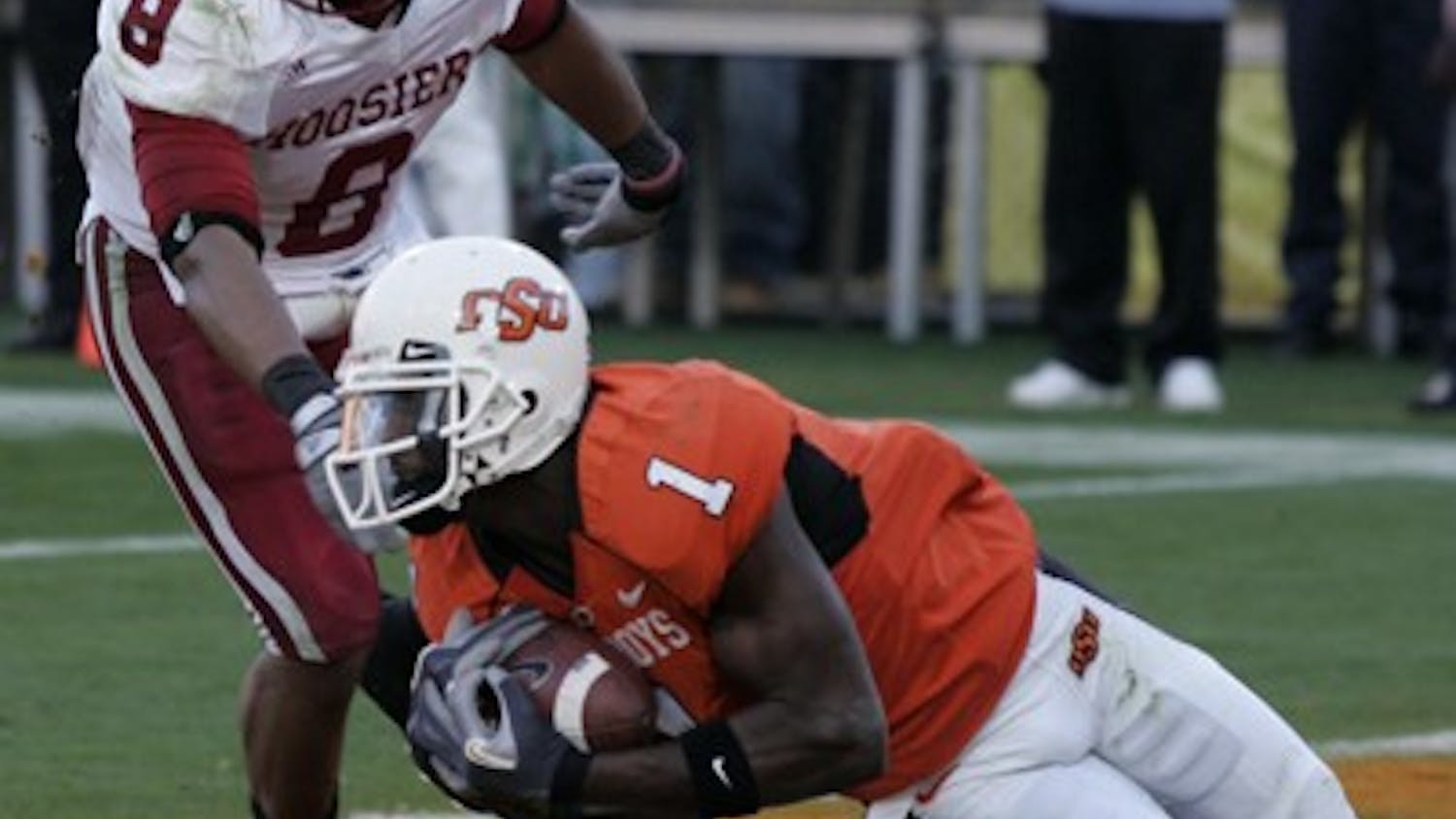 Jay Seawell IDS
Oklahoma State freshman wide receiver Dez Bryant hauls in a touchdown catch against IU junior safety Nick Polk during the first quarter of the 2007 Insight Bowl Monday night at Sun Devil Stadium in Tempe, Ariz.