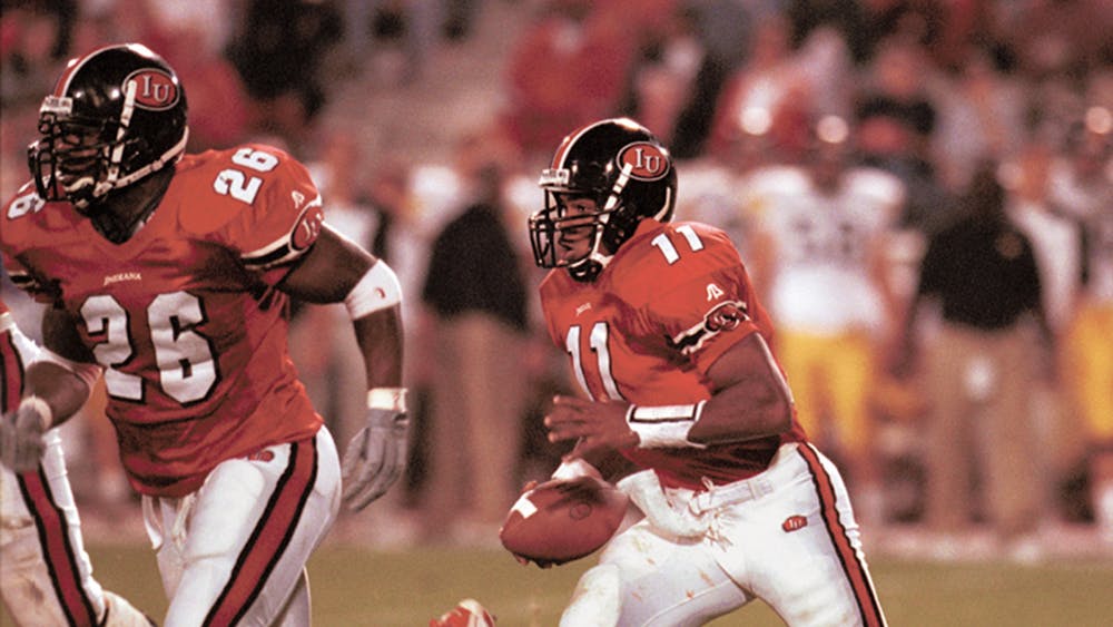 Former IU quarterback Antwaan Randle El begins the option with DeWayne Hogan at his side during the Hoosiers' 2000 victory against the Iowa Hawkeyes at Memorial Stadium. Randle El is one of two former Indiana football players included in the 2024 ballot for induction into the College Football Hall of Fame.