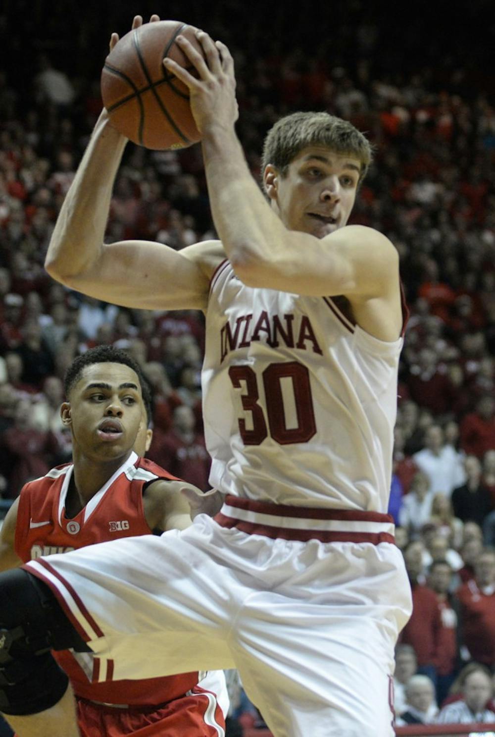Sophomore Collin Hartman grabs a rebound late in IU's game against Ohio State on Saturday at Assembly Hall.