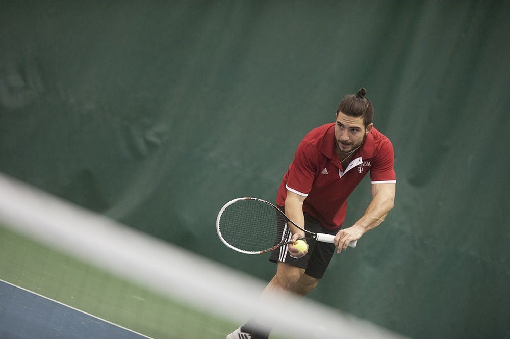 Sam Monnette prepares to serve in a singles match against Kevin Farin of Oregon University on Friday at the IU Tennis Center. Monnette won the game 7-6 (7-4), 6-4.