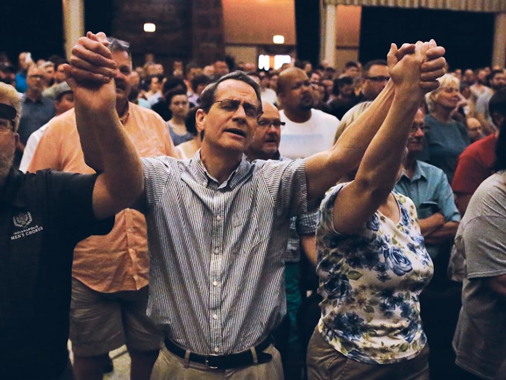 Jim Higginbotham raises his arms during a performance and sings the lyrics, "Hallelujah" along with the singer during a vigil, which took place in the Egyptian Room at the Old National Centre Sunday evening and was sponsored by Indy Pride in response to the recent mass shooting that took place at a gay night club in Orlando, Florida. 