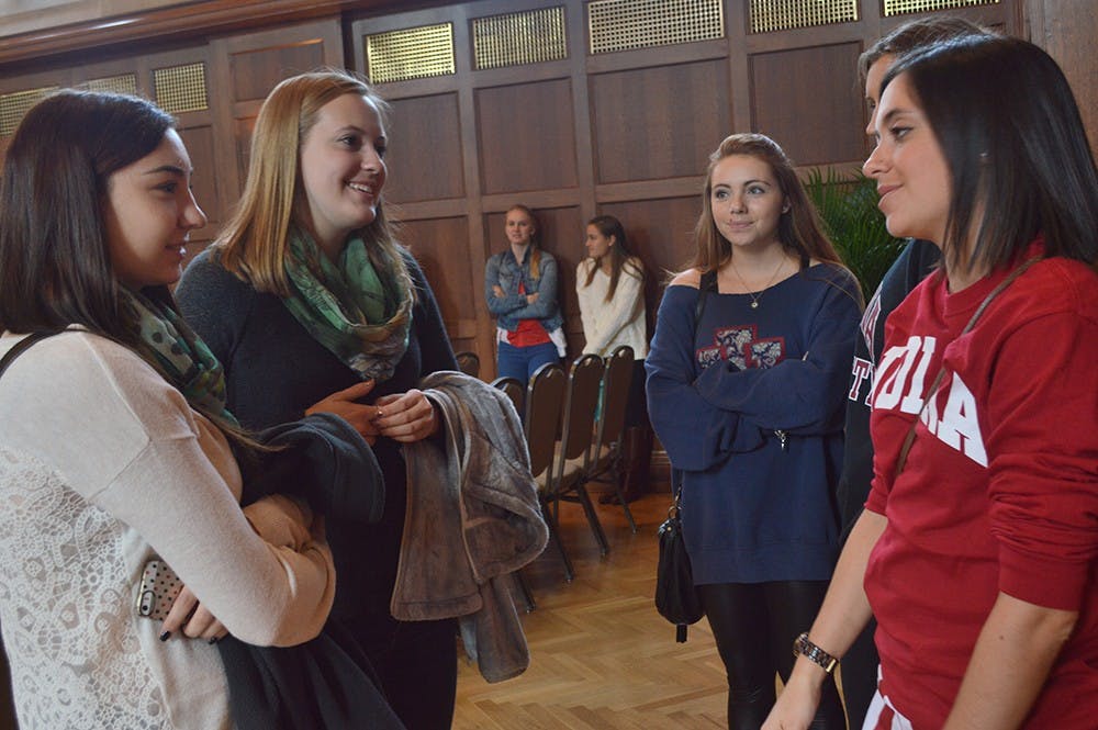 Women attending the Greek Opportunites for Women event speak with Rho Gammas, or recruitment couselors, after the presentation to ask questions about sorority recruitment process Sunday in Alumni Hall at the Indiana Memorial Union.