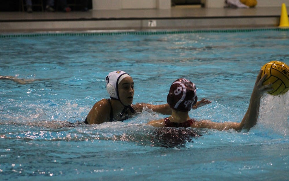 California Baptist University sophomore, Lizette Perez, reaches for the ball that IU junior Sarah Myers is defending during the match-up Saturday. Myers finished the game with one goal and one assist helping the Hoosiers defeat the Lancer 13-6.