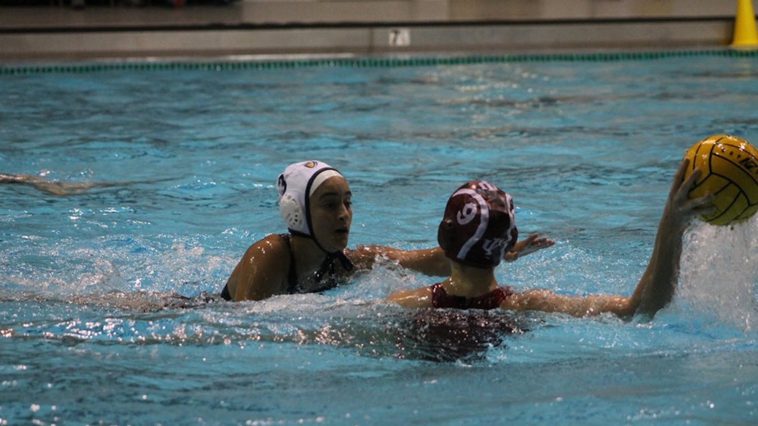 California Baptist University sophomore, Lizette Perez, reaches for the ball that IU junior Sarah Myers is defending during the match-up Saturday. Myers finished the game with one goal and one assist helping the Hoosiers defeat the Lancer 13-6.
