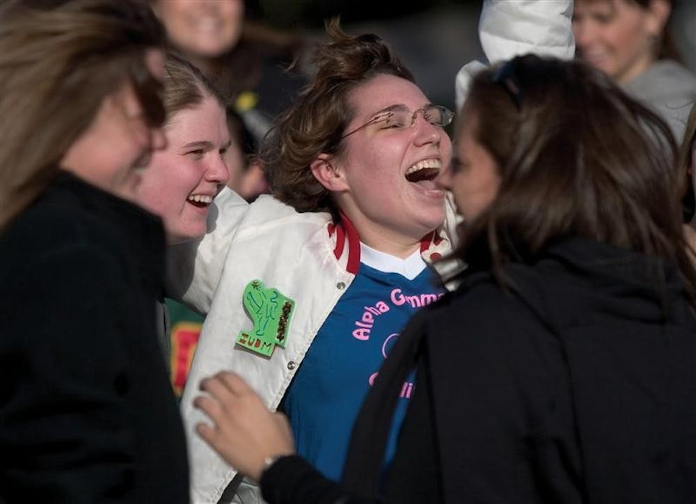 Then-senior Megan Hillier of Alpha Gamma Delta cheers while welcoming new members of her sorority in front of the AGD house in January 2006.