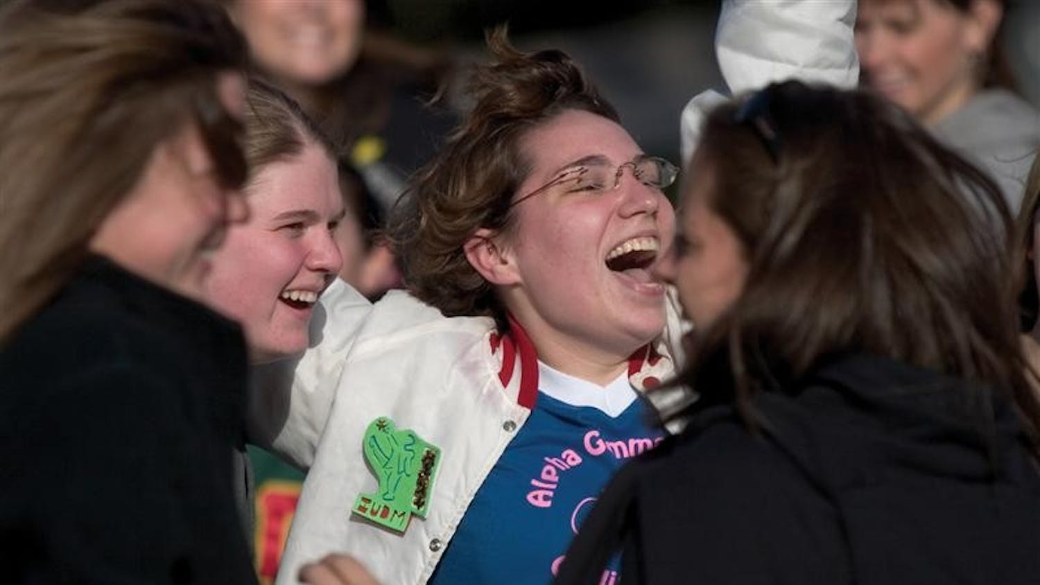 Then-senior Megan Hillier of Alpha Gamma Delta cheers while welcoming new members of her sorority in front of the AGD house in January 2006.