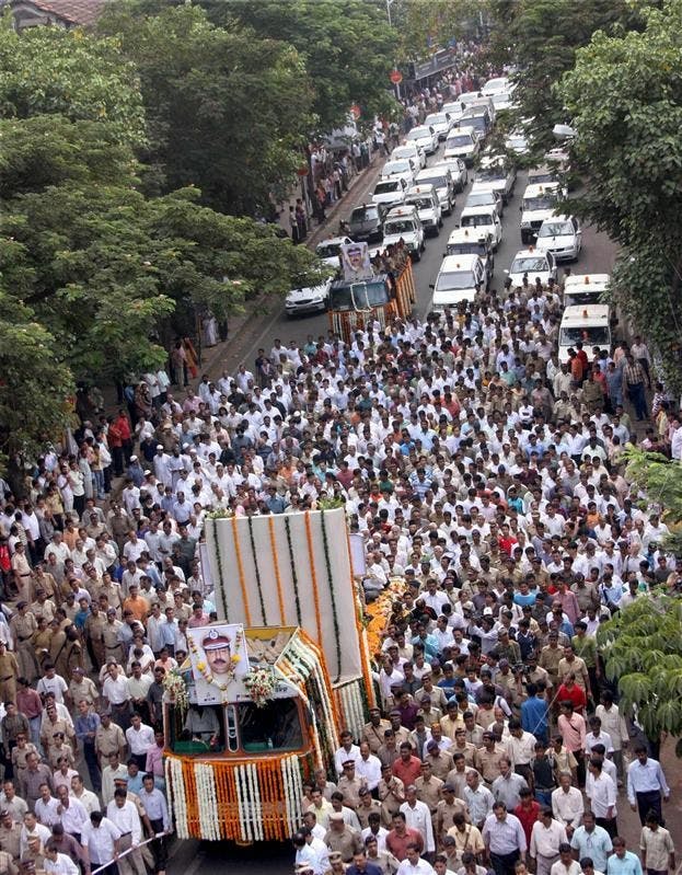 Citizens and police officers walk on Saturday during the funeral procession of Hemant Karkare, the chief of Mumbai's Anti-Terrorist Squad, who was killed by gunmen in Mumbai, India. Indian commandos killed the last remaining gunmen holed up at a luxury Mumbai hotel Saturday, ending a 60-hour rampage through India's financial capital by suspected Islamic militants that killed people and rocked the nation. 